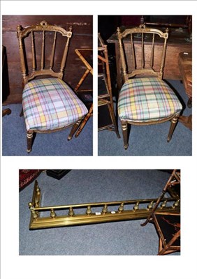 Lot 523 - Brass fender and a pair of carved gilt side chairs