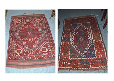 Lot 526 - Yuruk rug East Anatolia, the raspberry field with two hooked medallions enclosed by similar...