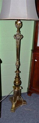 Lot 548 - A brass standing lamp with rams head decoration