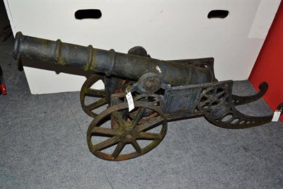 Lot 710 - A Victorian black painted cast iron model of a cannon, with 92cm triple ring barrel,...