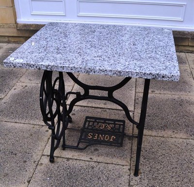 Lot 711 - Granite-topped garden table with sewing machine base