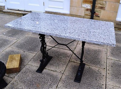 Lot 713 - Granite-topped garden table with cast iron base