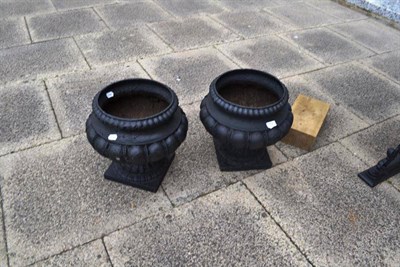 Lot 714 - A pair of cast iron urn planters