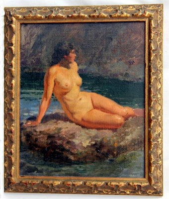 Lot 680 - Fortunino Matania RI (1881-1963) Italian A female nude resting on a rock beside cliffs Oil on...