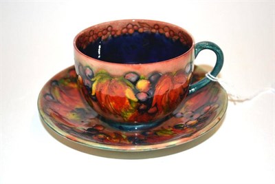 Lot 703 - A William Moorcroft Flambe Leaf and Grape Pattern Cup and Saucer, impressed MADE IN ENGLAND...