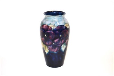 Lot 704 - A William Moorcroft Pansy Pattern Vase, on a blue wash ground, impressed factory marks and...