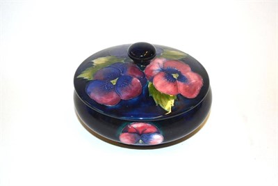 Lot 705 - A William Moorcroft Pansy Pattern Powder Box and Cover, on a blue ground, cover with impressed mark