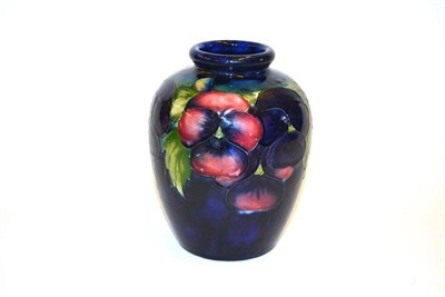 Lot 706 - A William Moorcroft Pansy Pattern Vase, on a blue ground, impressed facsimile signature and...