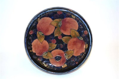 Lot 707 - A William Moorcroft Pomegranate Pattern Bowl, blue painted signature, impressed factory marks, 27cm