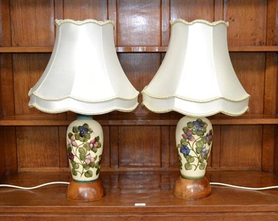 Lot 712 - A Pair of Walter Moorcroft Bougainvillaea Pattern Lamps, on a cream ground, 33.5cm high (mounted in