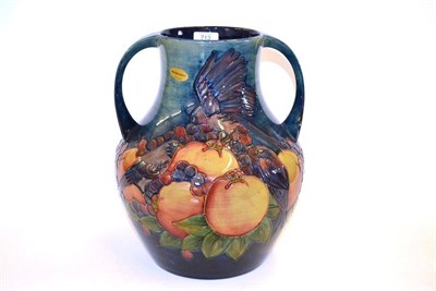 Lot 713 - A William John Moorcroft Finches Pattern Twin-Handled Vase, on a blue wash ground, impressed...