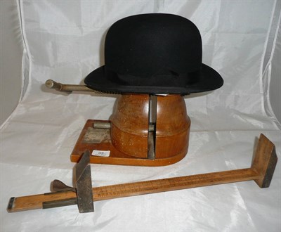 Lot 33 - A hat stretcher and bowler hat and a foot rule
