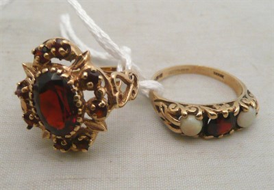 Lot 91 - A 9ct gold garnet and opal three stone ring and a 9ct gold garnet cluster ring