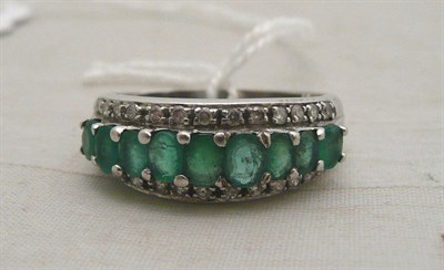Lot 118 - An emerald half hoop ring
