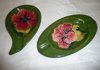 Lot 132 - Two Walter Moorcroft 'Hibiscus' green ground oval dishes
