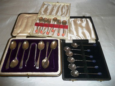 Lot 136 - A set of silver coffee spoons, a cased set of teaspoons and tongs and a set of plated coffee spoons