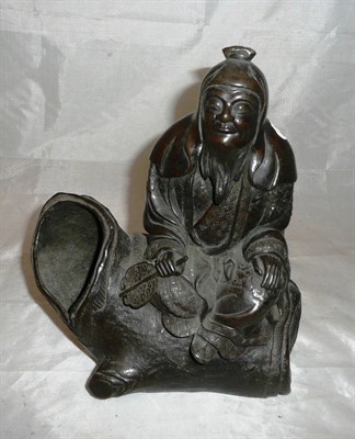 Lot 185 - Japanese bronze of a seated figure on a tree trunk