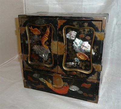 Lot 188 - An early 20th century Japanned cabinet decorated with fish  *by repute from the Perry Family of...