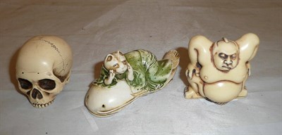 Lot 225 - Resin skull box, resin sumo wrestler and a resin group of a cat laying on a catfish (3)