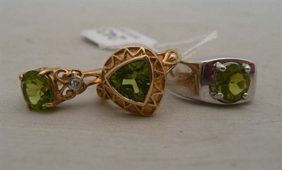 Lot 243 - Two 9ct gold peridot rings and a peridot ring in white mount stamped '9K'