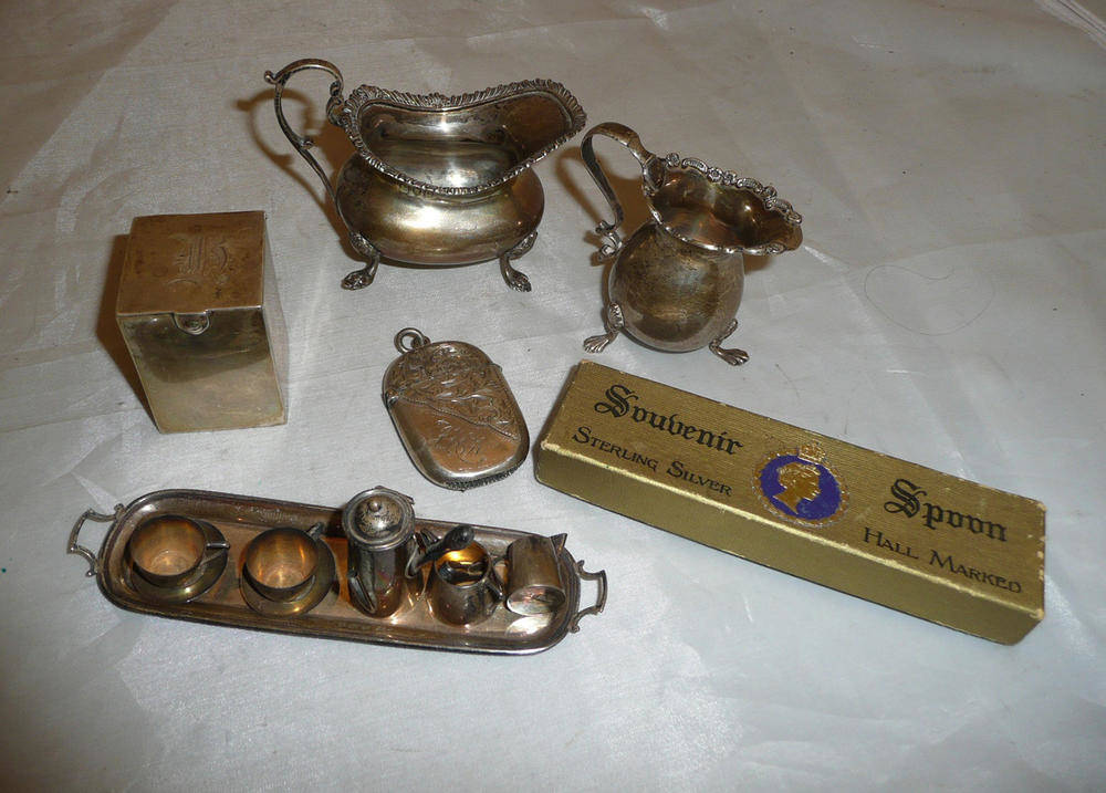 Lot 247 - A miniature silver tea service, two silver jugs, silver vesta case etc