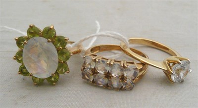 Lot 261 - A 9ct gold moonstone ring, a 9ct gold moonstone and peridot ring and a 9ct gold solitaire ring