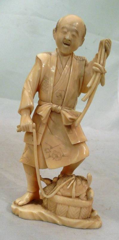 Lot 282 - A late 19th/early 20th century Japanese ivory fisherman with a terrapin on a lead and a basket...