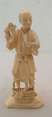 Lot 293 - 19th century Japanese ivory man with scissors standing over a basket