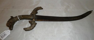 Lot 302 - A curved dagger with bronzed metal grip and quillons