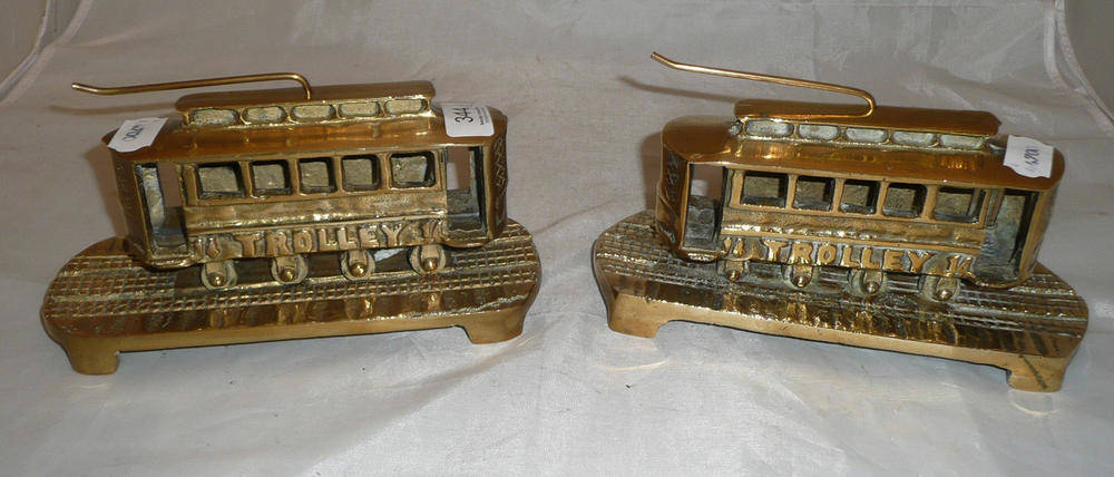 Lot 344 - A pair of brass 'tram' fireside ornaments