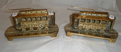 Lot 344 - A pair of brass 'tram' fireside ornaments