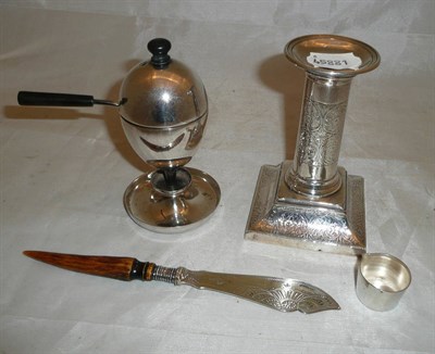 Lot 365 - A silver candlestick with engraved decoration, a plated egg coddler and a knife