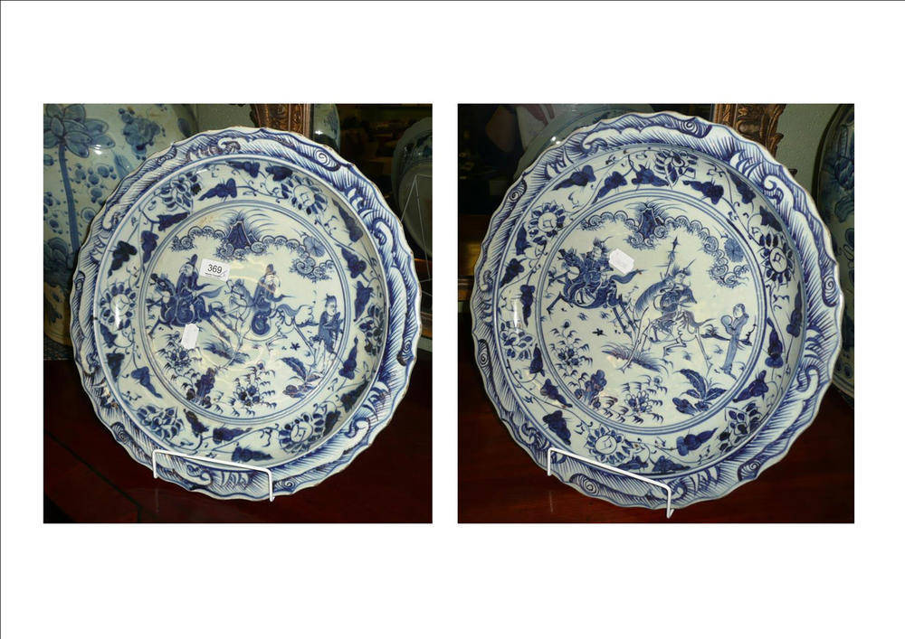 Lot 369 - Pair of blue and white chargers decorated with warriors