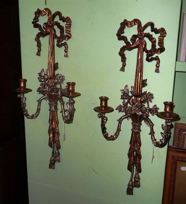 Lot 462 - A pair of gilt metal ribbon wall sconces