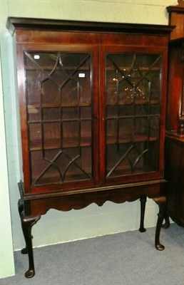 Lot 466 - A mahogany glazed cabinet on stand