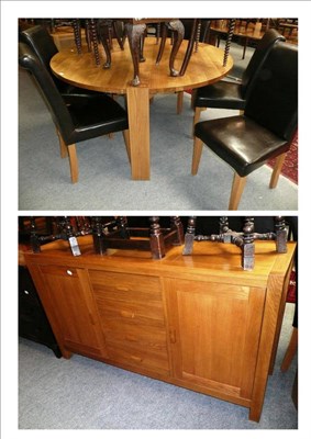 Lot 481 - A modern oak circular dining table, six chairs and an oak sideboard