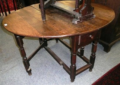 Lot 494 - An oak gateleg dining table