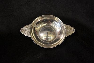 Lot 800 - An Arts and Crafts Silver Quaiche, by Robert Edgar Stone, the handles engraved with roses,...