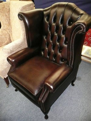 Lot 516 - Leather wing-back chair