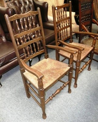 Lot 519 - A pair of rush-seated spindle back oak armchairs