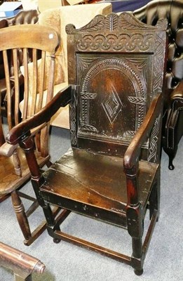 Lot 522 - A joined oak Wainscot chair, 17th century in part, with carved back panel above a boarded seat, gun