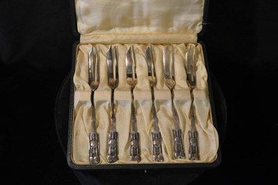 Lot 801 - Archibald Knox for Liberty & Co: A Set of Six Silver Cake Forks, each with honesty motifs to...