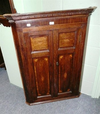 Lot 589 - George III oak hanging corner cupboard