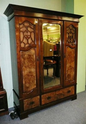 Lot 591 - An Edwardian walnut triple door wardrobe, with fitted panel doors and registration number