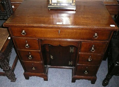 Lot 611 - George III oak kneehole desk