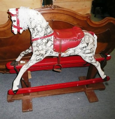 Lot 663 - A dapple grey rocking horse on a trestle base