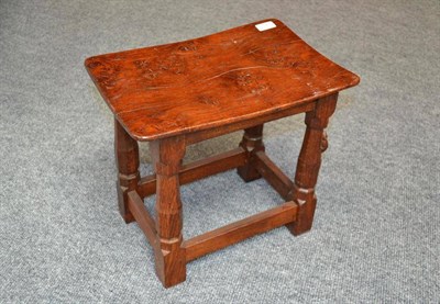 Lot 817 - A Robert  "Mouseman " Thompson Oak Dish Top Stool, the adzed top on four octagonal legs joined...