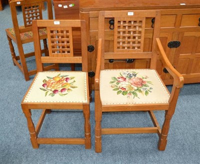 Lot 823 - A Robert  "Mouseman " Thompson Oak Lattice Back Dining Chair and Armchair, on turned octagonal...