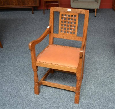 Lot 825 - A Robert  "Mouseman " Thompson Oak Lattice Back Carver Chair, with tan cow hide seat, on turned...