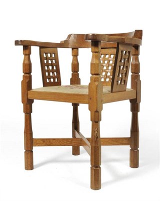 Lot 826 - A Robert  "Mouseman " Thompson Oak Monks Chair, with curved back and shaped arms, over three...